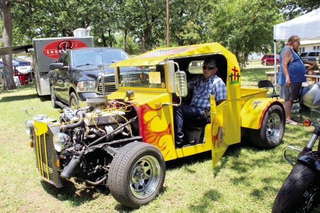 Bernie Higgins of Meeker sits in his 1948 Willis Jeep during the 36th Annual Knights Auto Club Car Show at Boy Scout Park on June 24. Higgins said he bought the Jeep, turned ratrod pickup, as is, but he painted the U.S. flag on the roof and eagles on either side of the back window. Countywide &amp; Sun/Natasha Dunagan
