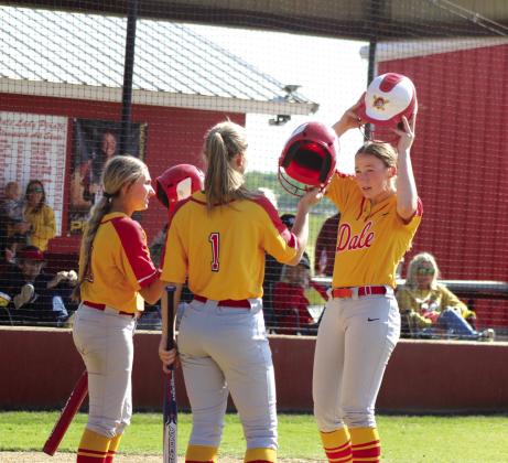 Dale’s Makenzie Ellis hits helmets with Kinsley Hill and Heartly Snyder after hitting a home run in the third inning.