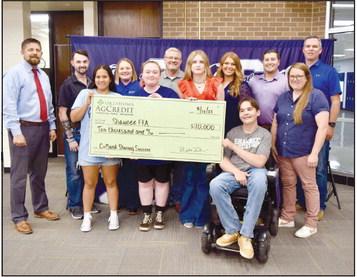 Shawnee High School FFA students, along with their teachers and Superintendent Dr. Aaron Espolt, receive a check in August for $10,000 from Oklahoma AgCredit to go toward the FFA program. Photo provided.