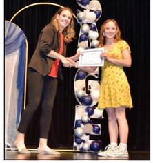 Shawnee High School Assistant Principal Megan Bloom (left) presents 11th Grader Evelyn Miner with a pin and certificate recognizing Miner as part of Shawnee Advanced Gifted Education (S.A.G.E.) in a recent ceremony. Photo provided