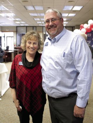 Kim Rawls poses with Arvest Community Bank President Brian Nave during her retirement reception on Dec. 30. Rawls worked for the bank for 43 years. Countywide &amp; Sun/Natasha Dunagan